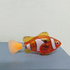 An orange and white light-up bath toy shaped like a fish with a translucent yellow trumpet.