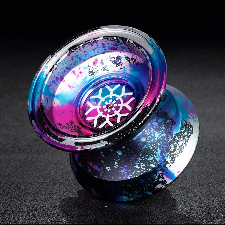 A close-up of a professional aluminum alloy yo-yo with high-speed ball bearings showing iridescent purple and blue colors.