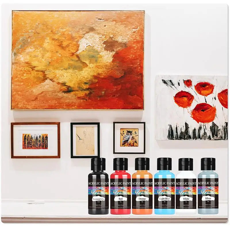 A set of twelve bottles of 24-color acrylic paint in various shades of red, orange, yellow, and blue.