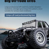 A black high-speed 4WD RC monster truck with large off-road tires and LED lights on a rocky terrain.