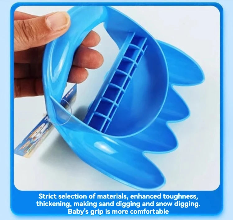 A hand holds a blue dinosaur claw digging toy designed for sand and snow digging.