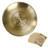 A round, brass-colored altar plate featuring a star design, accompanied by ritual parchment cards.