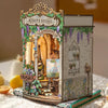 A detailed miniature wooden book nook kit depicting Monet's Studio with an arched window and floral details.
