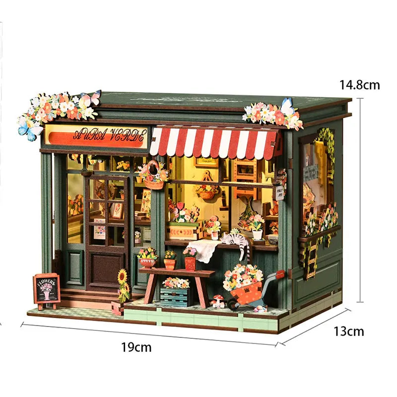 A miniature vintage music room book nook kit featuring a wooden facade, striped awning, and detailed interior display.