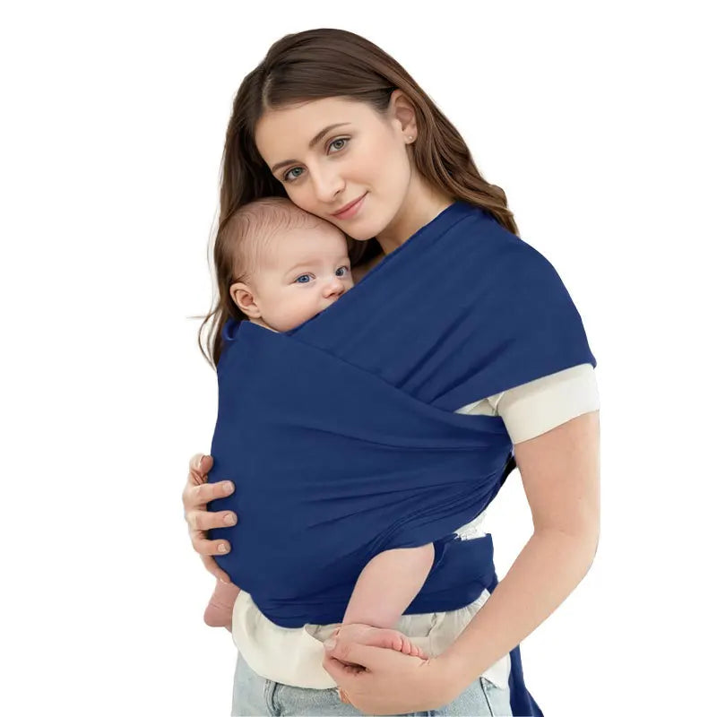 A woman is holding a baby in an ergonomic multi-functional baby sling carrier.