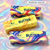 Three squishy butter bars in marbled yellow and purple colors are displayed on a shiny surface.