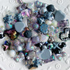 A collection of iridescent and dark acrylic bow and flower beads for DIY jewelry making