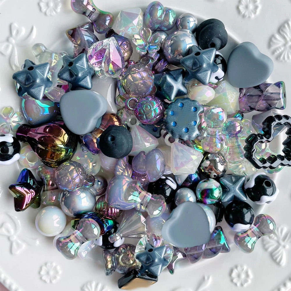 A collection of iridescent and dark acrylic bow and flower beads for DIY jewelry making