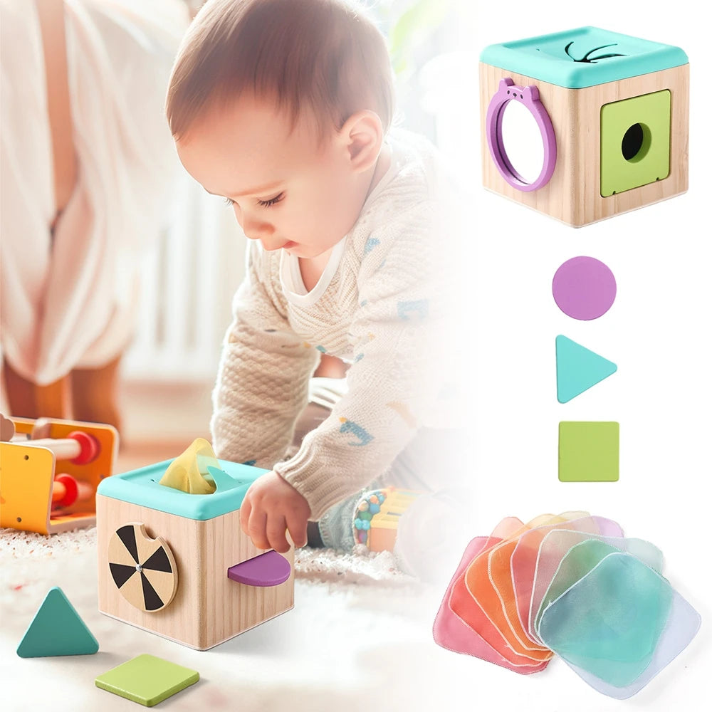 A wooden tissue box toy for toddlers with various colored silicone tissues and fine motor skills components.