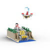 A 490-piece construction kit of a UFO robot model built from LEGO bricks, featuring a red and silver robot and surrounding te