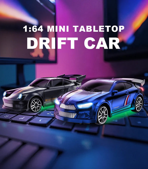 A miniature 1:64 scale drift car model in blue and black sits on a keyboard surface.