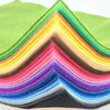 A fan of vibrant felt fabric sheets arranged in a colorful chevron pattern.