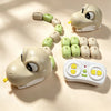 A beige magnetic snake toy with green segments and a white remote control is shown on a light background.