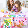A girl is crafting with gem stickers on paper, showing examples of face, nail, and craft designs.