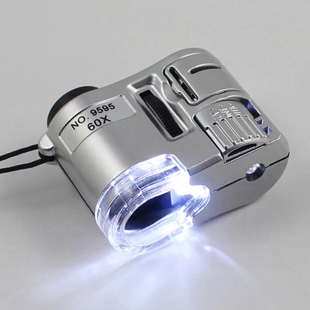 Silver handheld magnifying glass with an LED light, showing a bright beam.