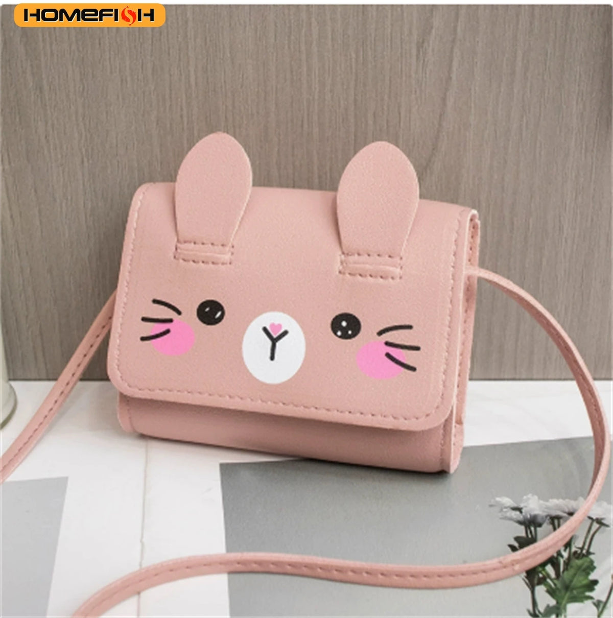 A pink cat-shaped mini PU leather crossbody handbag with long ears and a pink strap.