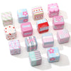 A collection of pink acrylic flower print beads with bow charms for DIY phone and bag accessories.