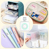 A collection of stationery items including notebooks, carbon paper, pens, and a vitamin organizer are shown.