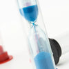 A clear hourglass filled with blue sand, showing a time measurement.