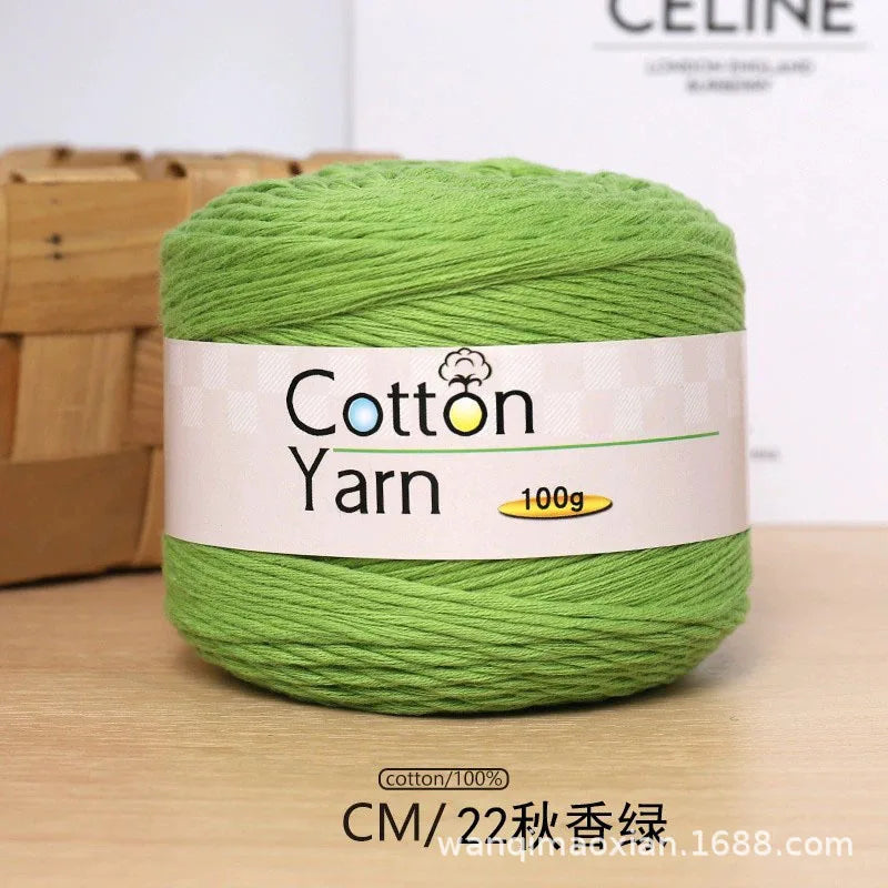 A ball of bright green 100% cotton yarn labeled Cotton Yarn for knitting and crochet.