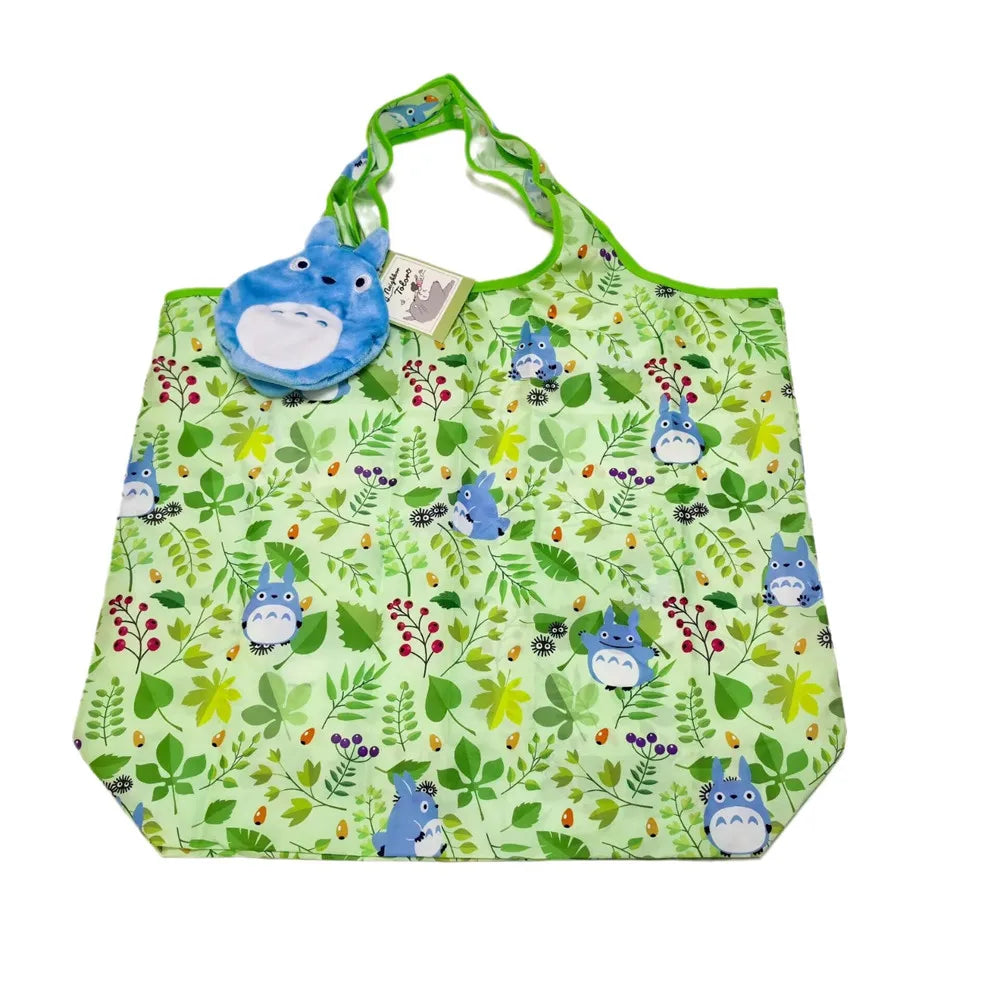 A green fabric bag featuring a pattern of small blue and yellow leaves and berries, with a blue plush toy attached.