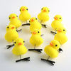 A set of yellow 3D duck plush hair clips with black metal arms arranged in a circle.