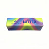 A rectangular block of salted butter labeled 4oz butter net wt 113g with a colorful gradient background.