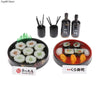 A set of miniature Japanese sushi rolls displayed in a black bowl with chopsticks and a bottle.