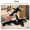 A black and white lifelike orca whale plush toy is displayed next to a person for scale, with dimensions of 75cm and 1.3m.