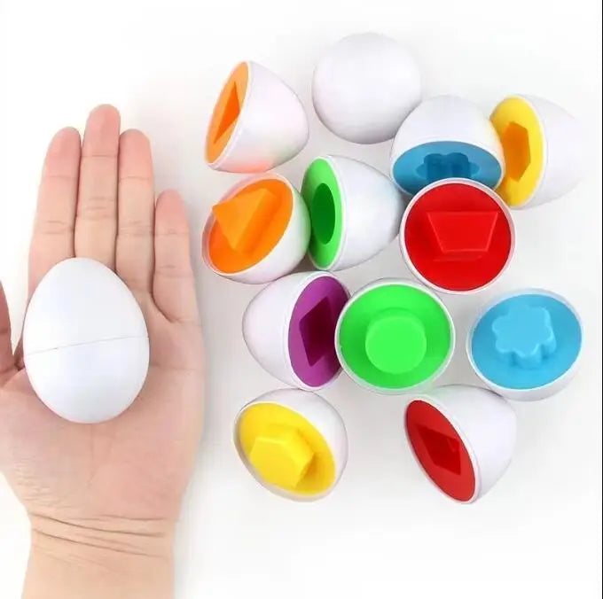 A hand holds multiple colorful, egg-shaped sorting toys for toddlers.
