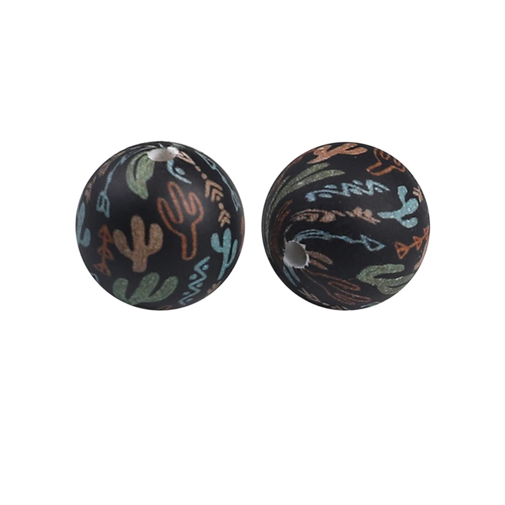 Two dark silicone beads with a natural pattern of green and brown cacti designs.