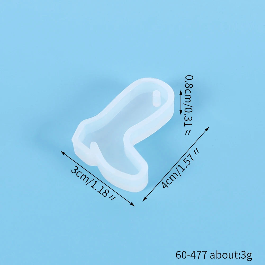 A clear silicone mold shaped like a festive Christmas ornament for jewelry and craft projects.