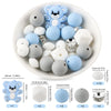 A white bowl filled with various blue and white silicone beads shaped like cartoon animals for DIY jewelry making