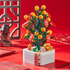 A building block set depicting a bouquet of orange roses and green foliage on a white base.