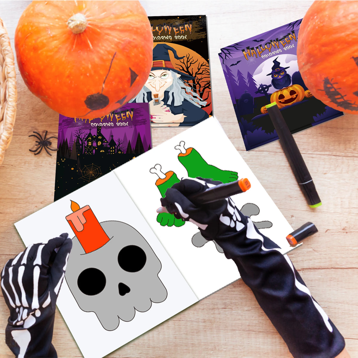 A Halloween coloring book set featuring festive pages, a pumpkin, and a skeleton design on a wooden surface.