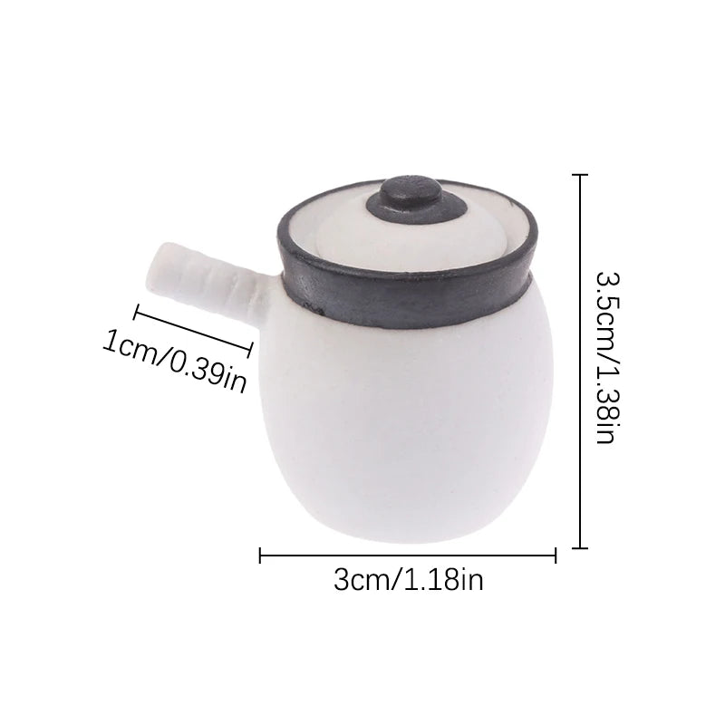 White miniature copper soup pot with a lid and spout shown against a white background.