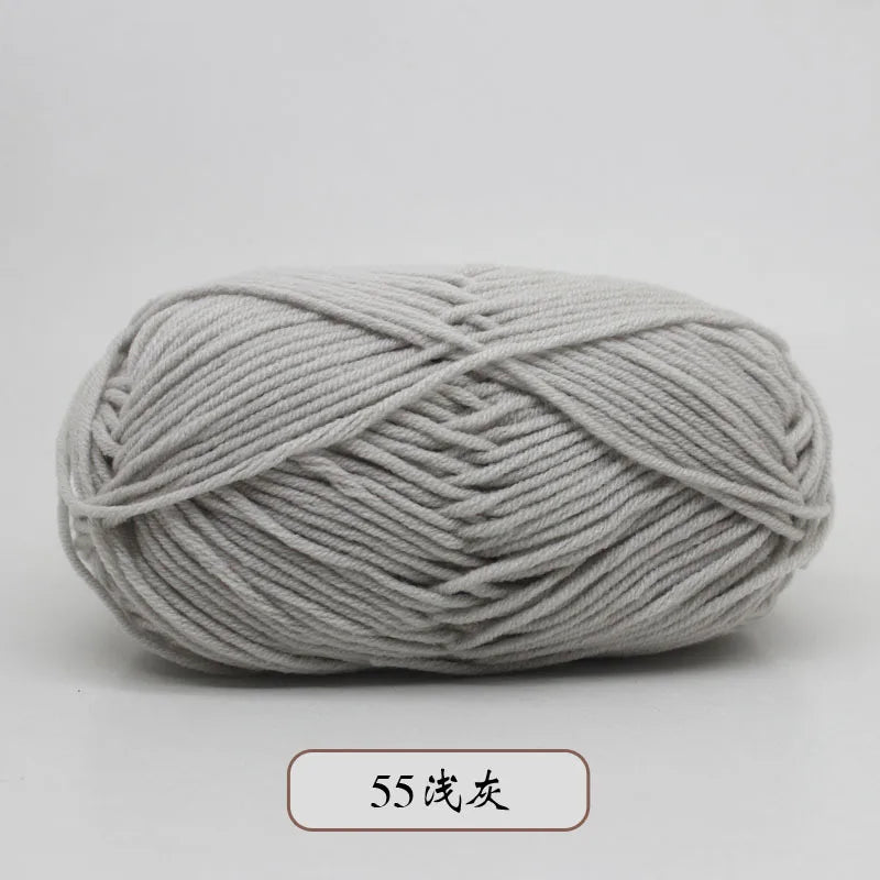 A ball of light gray pre-dyed milk cotton yarn, 50g, used for knitting and crochet.