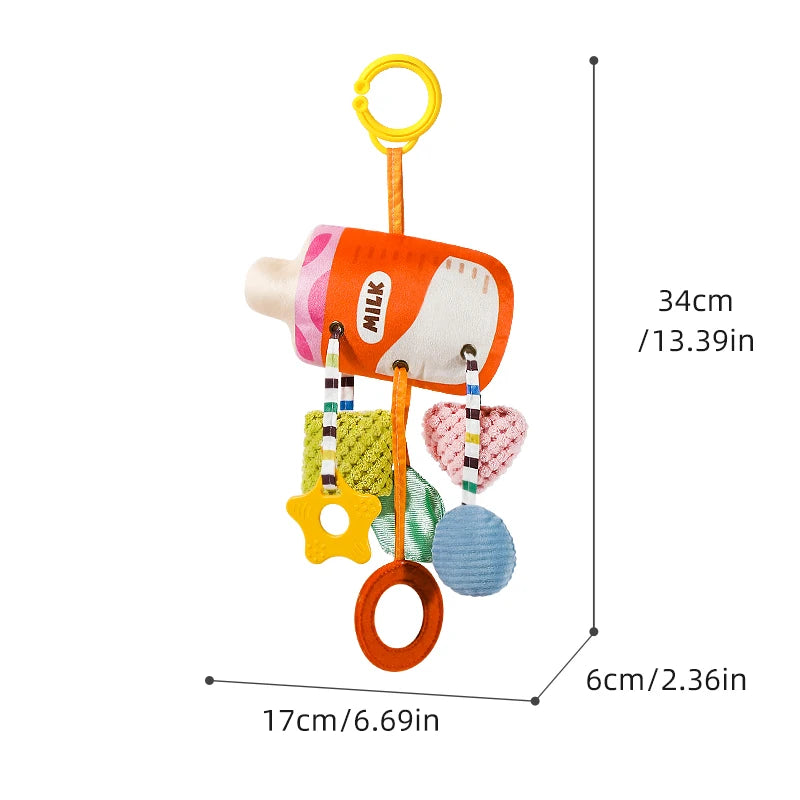 An orange milk-themed baby rattle and teether toy with a yellow hanging strap.