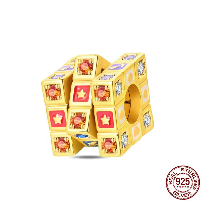 A yellow 925 sterling silver rotatable Rubik's cube charm for bracelets featuring colorful gems.