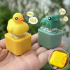 A yellow duck and green frog fidget clicker keychain with sound and LED light held in a hand.