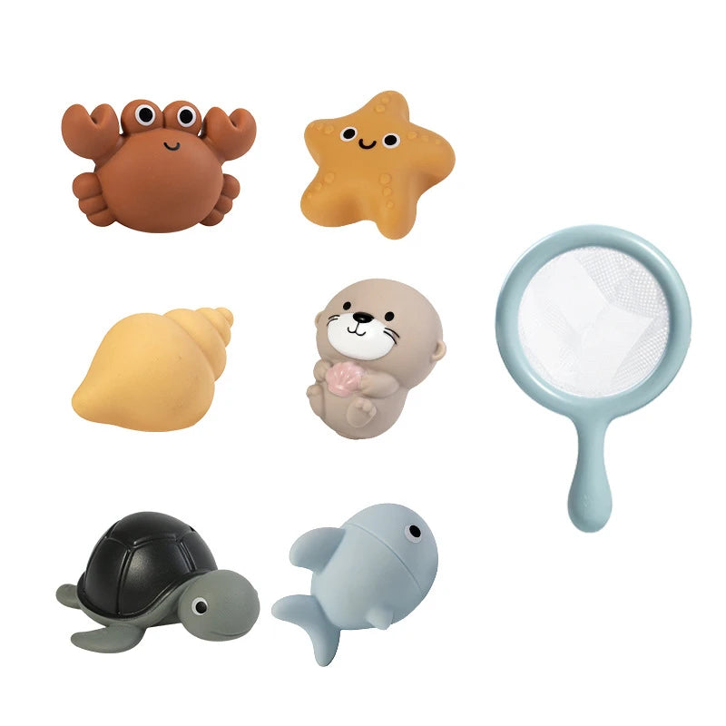 A set of five silicone bath toys shaped like a turtle, a starfish, a yellow egg, a cat, and a turtle, including a fishing net