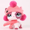 A pink and white cat bobble head figurine wearing a pink knitted hat and a sparkly face paint.