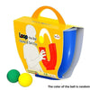 An orange box for a U-shaped juggling ball skill toy with green and yellow balls.