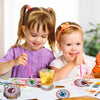 Two young girls are decorating DIY diamond art coasters with a spider web design.