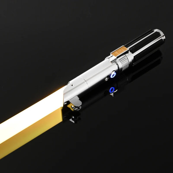 A close-up view of an RGB metal lightsaber toy with a gold hilt and illuminated blade against a dark background.