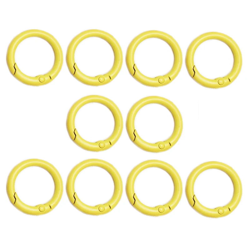 A set of ten yellow alloy snap hook keychain clips arranged in two rows.