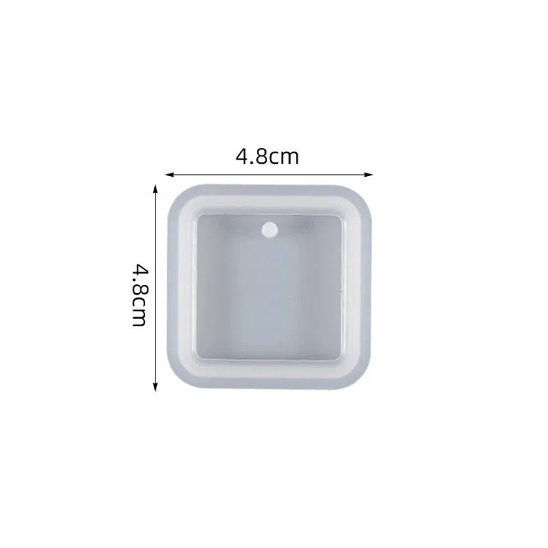 A rectangular silicone mold with rounded corners and a small circular indentation for resin jewelry making.