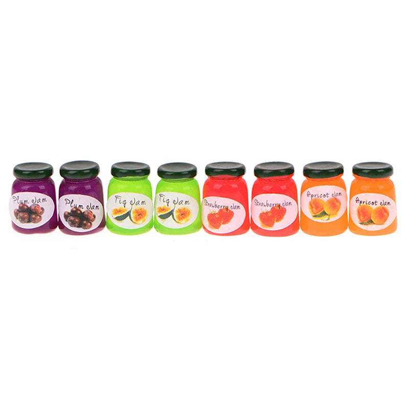 A set of miniature ceramic jam jars in various fruit colors including plum, lime green, and red apricot.