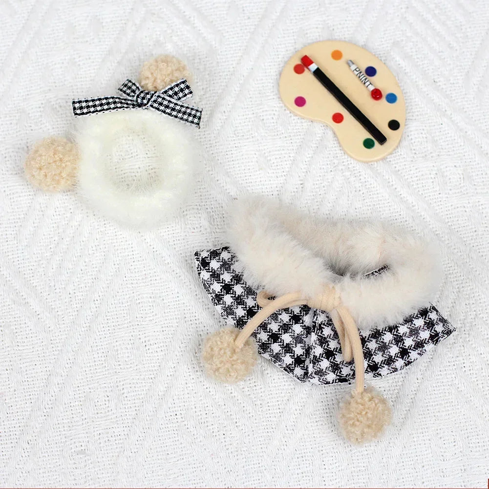 A set featuring a black and white grid cape and beret with fluffy trim and a colorful grid-patterned disc.
