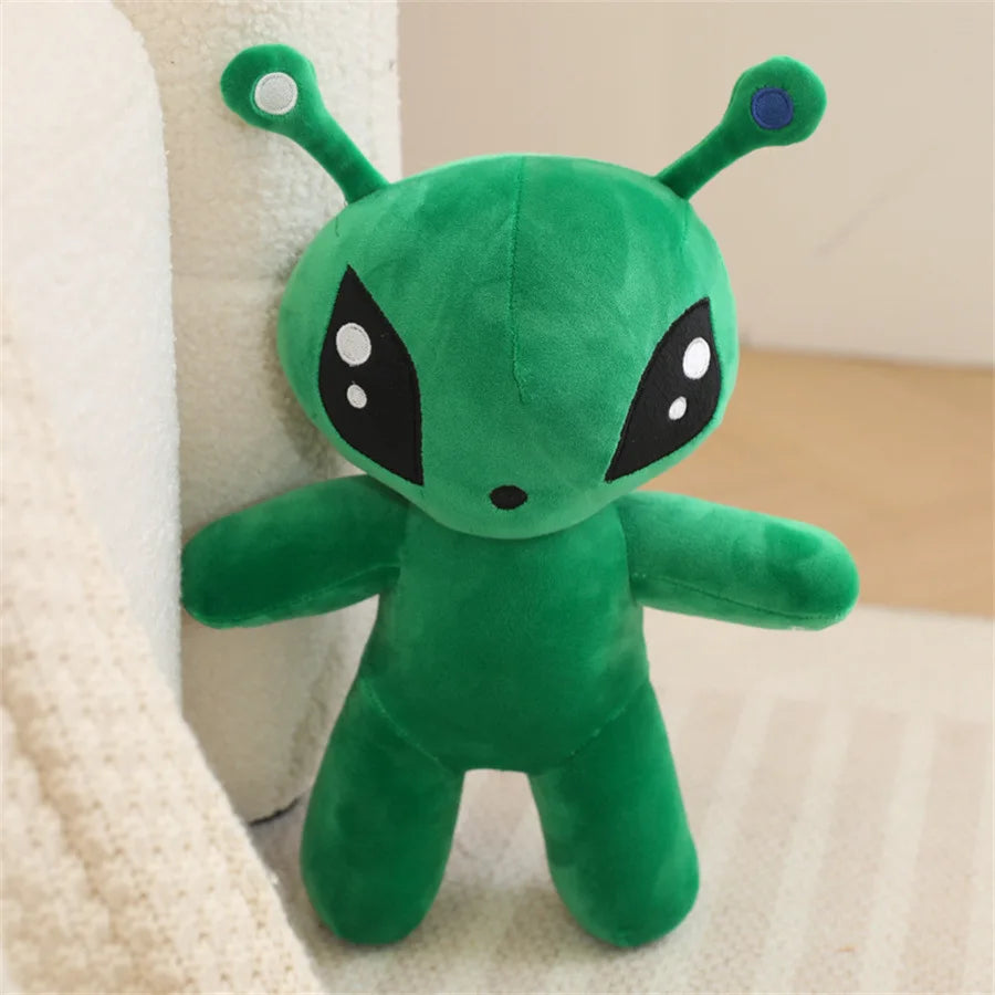 Adorable green alien plush toy with long ears featuring a blue detail on the head.